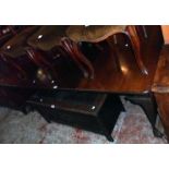 A late Victorian mahogany extending dining table with three leaves and winder, set on heavy cabriole