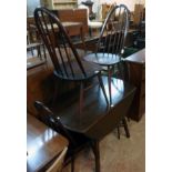 A 3' 8" Ercol dark stained elm drop-leaf dining table, set on moulded splayed supports - sold with a