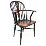 A Georgian comb back elbow chair with twin pierced splat back and moulded solid elm seat, set on