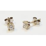 A pair of white metal diamond solitaire stud ear-rings with butterflies marked 750 - 0.50ct. TDW