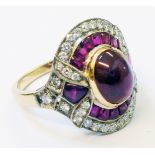 A 1920`s style marked 18k yellow metal ring, set with central cabochon ruby within a paved ruby