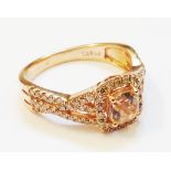 An import marked 585/14k rose gold ring, set with central morganite within a diamond encrusted