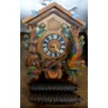 A 20th Century painted wood and resin cuckoo wall clock with pine cone pattern weights - a/f