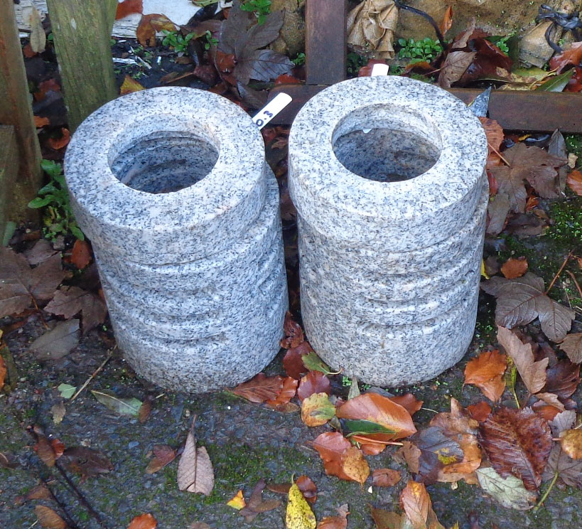 A pair of polished granite garden light holders