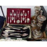 Three cased sets of silver plated cutlery, a pair of silver plated copper telescopic candlesticks (