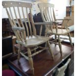 A pair of 20th Century blonde wood high lath back elbow chairs with solid sectional seats, set on