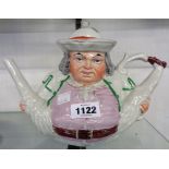 A 19th Century Staffordshire teapot in the form of Toby with his legs akimbo