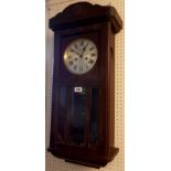 An early 20th Century oak cased wall clock with visible pendulum and Gustav Becker eight day gong