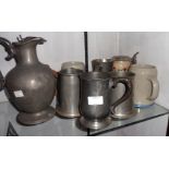 A small collection of various pewter and other tankards