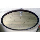 An Edwardian mahogany and strung framed bevelled oval wall mirror