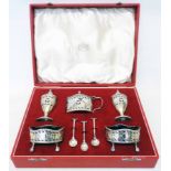 A cased 1960 silver five piece condiment set in the Georgian style comprising two salts, two