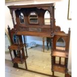 A 4' 3" Edwardian walnut ornate overmantel mirror with multi arcaded and oblong plates, an array