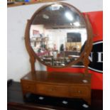 A mahogany and strung framed platform dressing mirror with circular plate and three drawers to base,