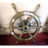 A small vintage brass and teak six spoke ship's wheel