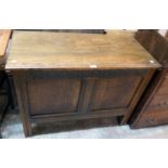 A 3' 6" oak two panel coffer with moulding and carved decoration, set on simple block feet