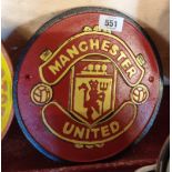 A reproduction painted cast iron Manchester United football sign