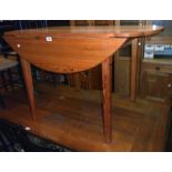 A 4' modern Swedish polished pine drop-leaf kitchen dining table, set on moulded square tapered legs