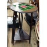 A 15 1/2" diameter Arts and Crafts style walnut occasional table with tile inset top and slender