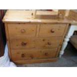 A 36" waxed pine chest of two short and two long graduated drawers, set on plinth base