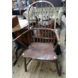 An antique stained elm comb back country elbow chair with solid seat panel and simple turned