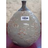 A raku pottery bottle vase with moulded decoration