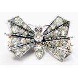 A 1 1/8" wingspan Victorian diamond encrusted butterfly pattern brooch with sprung articulated