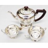 An Art Deco silver three piece tea set with banded decoration, composite knop and handle to teapot -