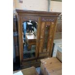 A 4' 3 1/2" Edwardian walnut and figured panelled double wardrobe with moulded dentil cornice and