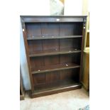 A 3' 6" early 20th Century stained oak four shelf open bookcase with flanking decoration and