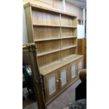 A 7' 3" old waxed pine and part painted two part dresser with central spindles to the four shelf