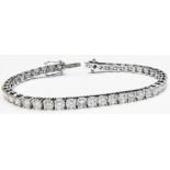 A marked 18k white metal bracelet, each of the links set with an individual brilliant cut