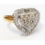 A hallmarked 750 gold heart shaped ring, set with diamond cluster within a baguette diamond border