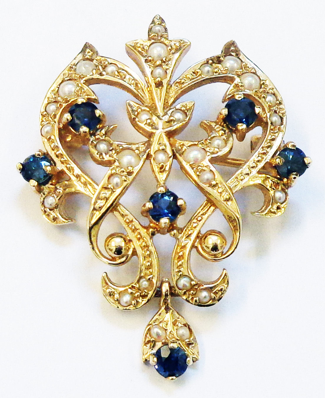 A hallmarked 375 gold Edwardian style open scroll pendant/brooch encrusted with seed pearls and