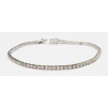 A marked 750 white metal bracelet, each of the links set with an individual brilliant cut