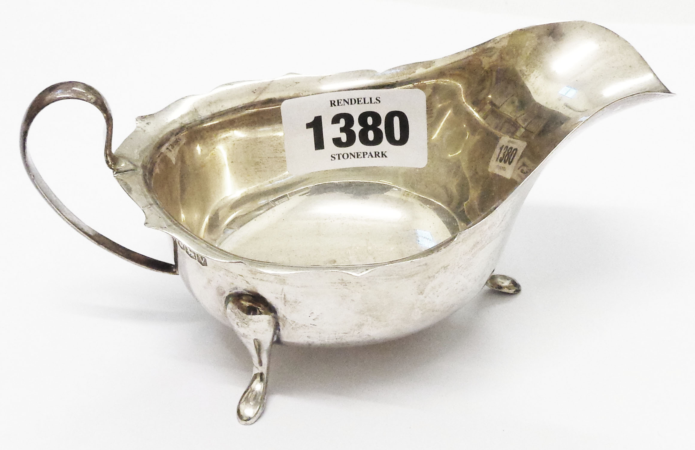 An Edward Viner silver gravy boat with shaped rim and pad feet - Sheffield 1963