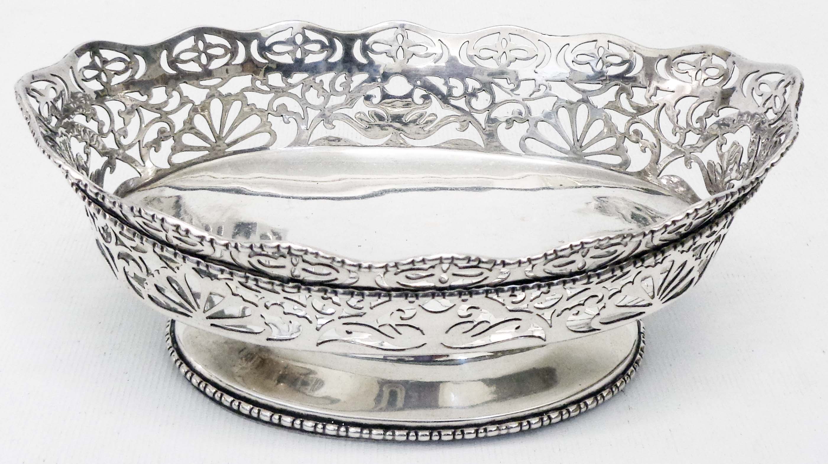 An 8 1/4" silver oval pedestal bowl with pierced decoration and beaded foot - Birmingham 1913