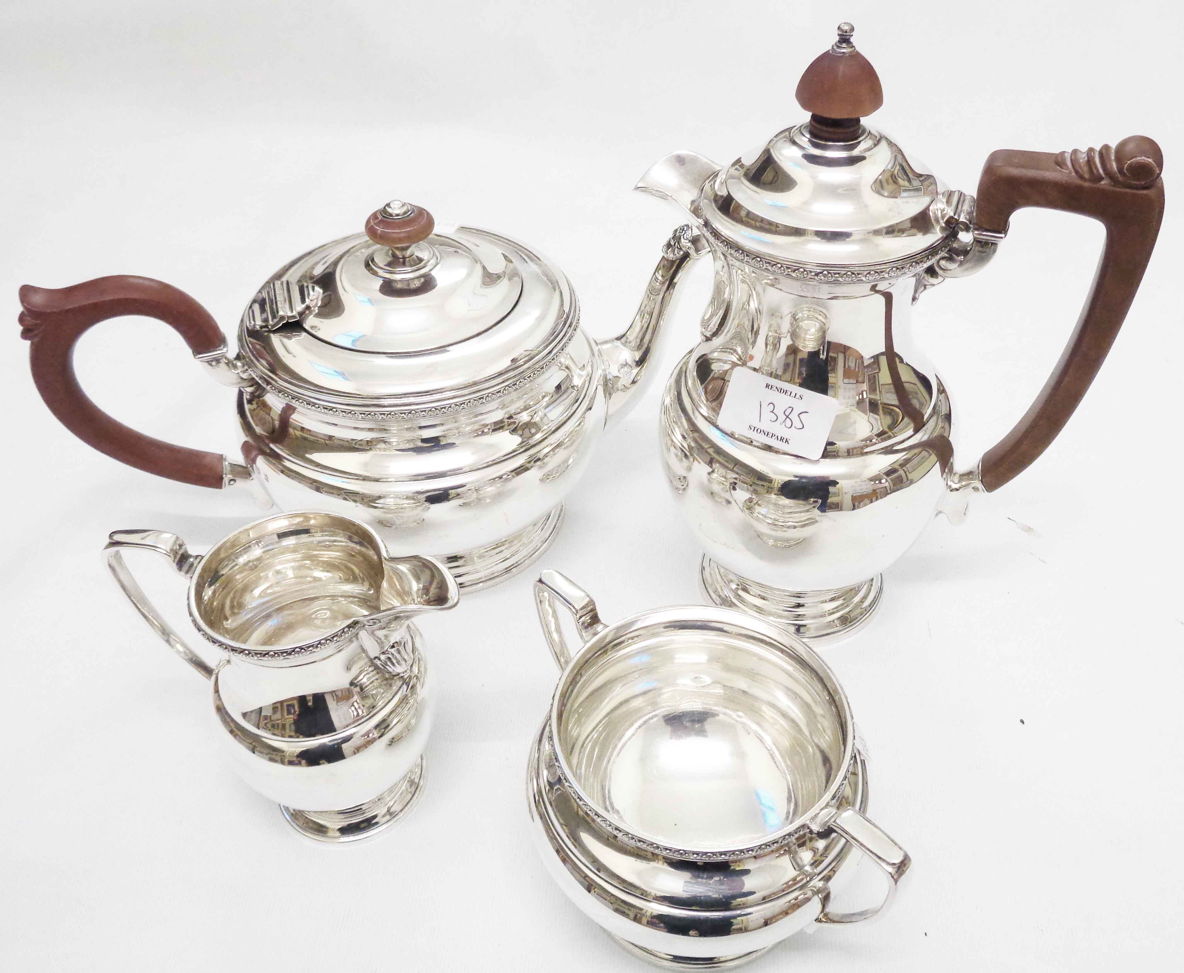 A William Greenwood & Sons silver three piece tea set of baluster form with decorative cast rims -