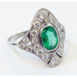 A marked PLAT 1920`s style oval panel ring, set with central oval emerald within a pierced diamond