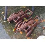 A pair of small cast iron cannon ornaments with rusted finish