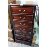 A 20" polished wood CD storage unit in the form of a chest with faux flight of seven drawers, set on