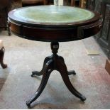 A 23" diameter reproduction mahogany drum table with green leather inset top and three frieze