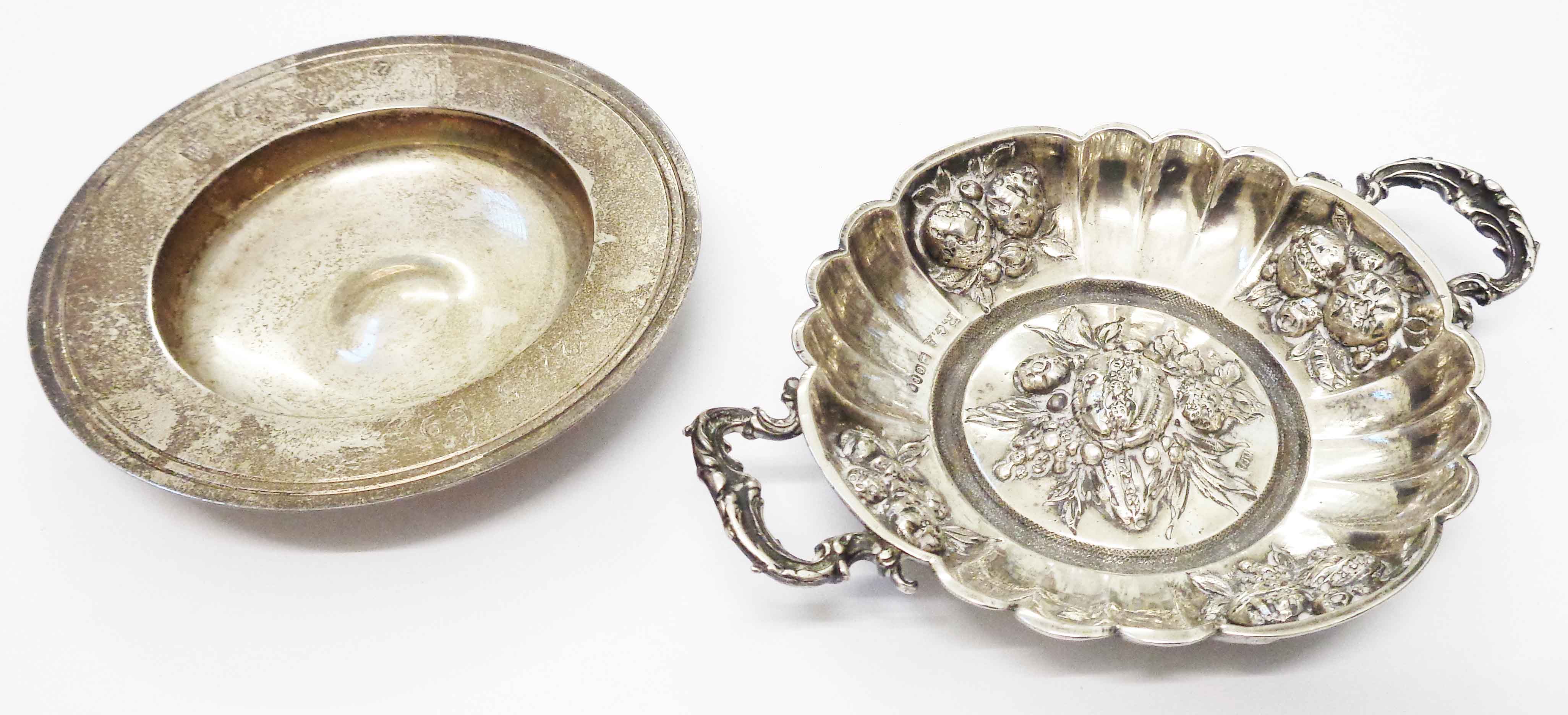 An ornate British hallmarked and stamped 930 wine taster with embossed fruit decoration, scalloped