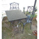 A patio table with cast iron sewing machine base and reconstituted black marble top - sold with a