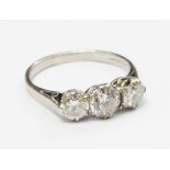 A high carat white metal three stone diamond ring - marks worn - approx. 1.2ct. TDW