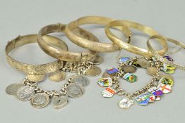 FIVE BANGLES AND TWO BRACELETS to include four hinged bangles, a belcher link charm bracelet