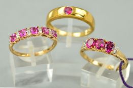 THREE 9CT GOLD PINK STONE GEM SET RINGS to include a single stone rub over set band, assessed as