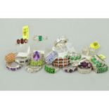 TWENTY MAINLY GEM SET RINGS to include a three row garnet ring, a three stone ruby ring, an oval