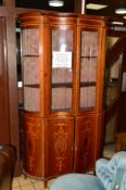A SHERATON REVIVAL MAHOGANY AND SATINWOOD BANDED SERPENTINE FOUR DOOR DISPLAY CABINET, the upper