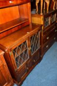 AN OAK LEAD GLAZED TWO DOOR BOOKCASE and a similar Old Charm oak TV cabinet (2)