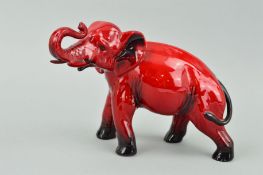 A ROYAL DOULTON FLAMBE ELEPHANT, trunk in salute, approximate height 13.5cm